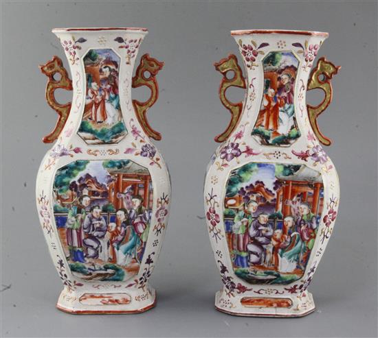 A pair of Chinese famille rose Mandarin hexagonal baluster vases, Qianlong period, height 27.5cm, slight damage